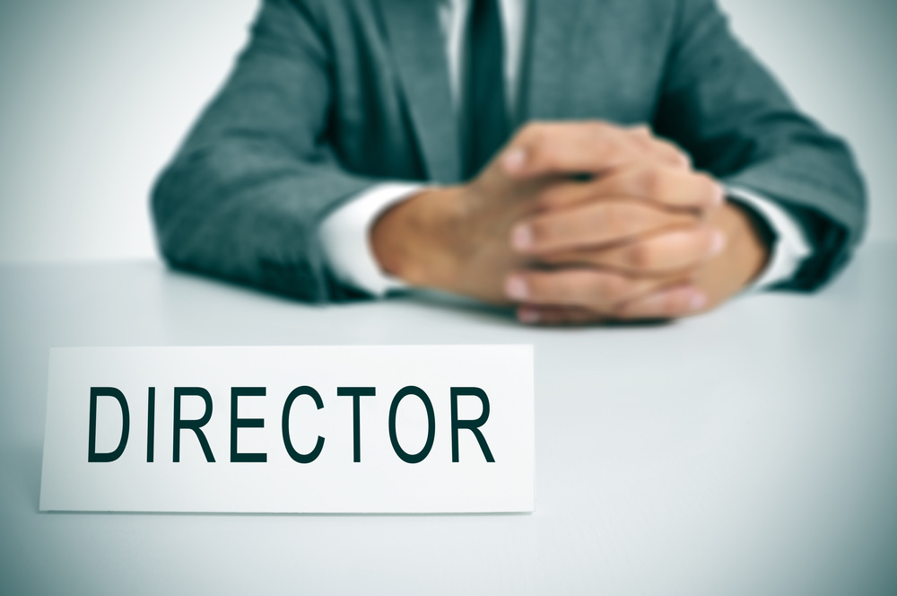 A,Man,In,Suit,Sitting,In,A,Desk,With,A Business Registration